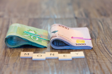 Nigerian Naira and Canadian Dollars with Money spelled out in letter tiles