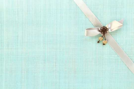 Gift ribbon on ramie fabric background. Holidays concept. 