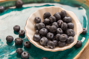 Healthy eating. Blueberries in small  white ceramice plate