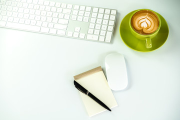 Modern White office desk table with pen and notebook,cup of coffee. Top view with copy space.Working desk table concept.