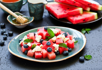 Salad from watermelon, with cheese, berries and mint.