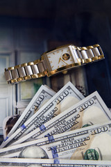 Five Hundred dollar, golden watch and men parfum on dark blue background