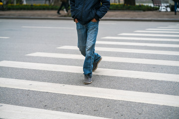 People walking across a street in Hanoi, Vietnam. Closeup