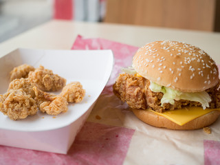 Fried chicken cheese burger with many pieces fried chicken.