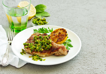 Pork cutlet on a bone with gremolat sauce.