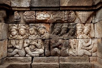 Ancient bas-reliefs on the walls of the Borobudur temple. Indonesia. Java island.