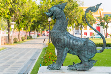 Naklejka premium Singha or the lion statue in front of Thai temple represent the guardian who protect the temple from the evil