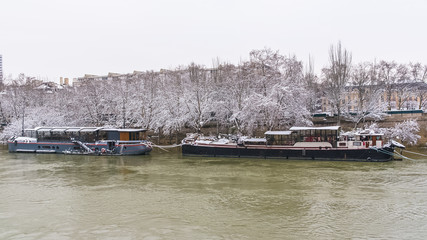 Paris, panorama of the Seine in winter, houseboats on the river 
