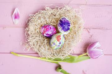 Easter Eggs  with Tulip Flower on a Pink Wooden Background
