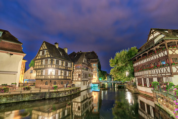 Naklejka premium Strasbourg Half Timber House night city skyline with Ill river, Strasbourg, France 4K Time lapse