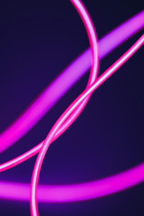Abstract image of a neon pink lighting line on dark