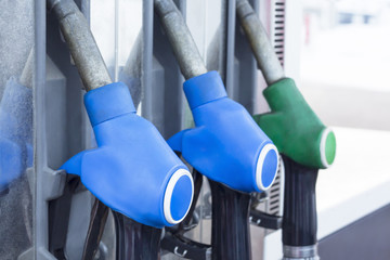 Gas station in service. Colorful Petrol pump filling nozzles. News about raising price of fuel.