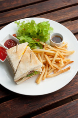 club sandwich with french fries on side