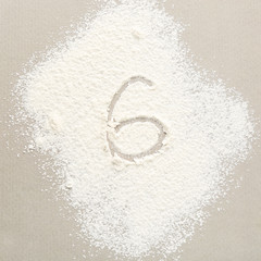 Figure SIX written on flour