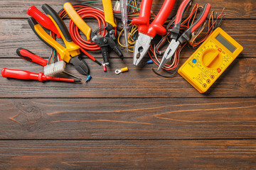 Different electrical tools on wooden background