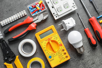 Different electrical tools on grey background