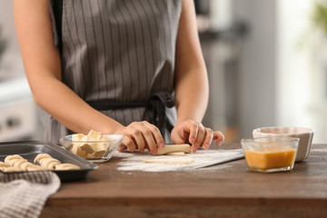 Woman preparing croissants in kitchen