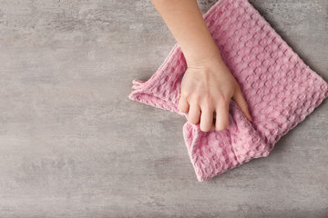 Woman wiping table with kitchen towel