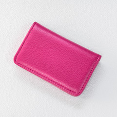 Pink leather card holders on synthetic white background. Top view of Leather wallet for keep your money.
