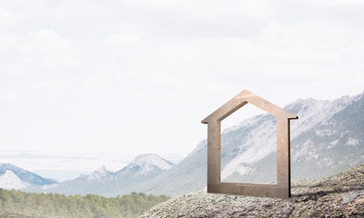 Conceptual image of concrete home sign on hill and natural landscape at background