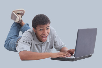 Happy african man with a laptop - isolated over white