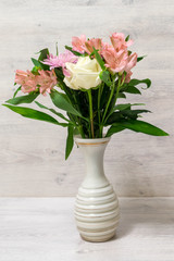 Colorful spring bouquet of rose, chrysanthemum and alstroemeria flowers in a vase