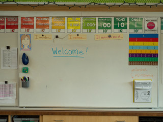 Grade school classroom white board with welcome written