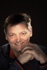 portrait of a man in the studio on a dark background.