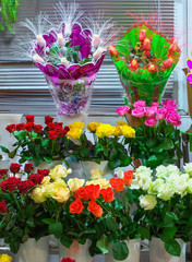 Beautiful colorful roses for sale at a florist's shop.