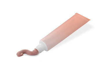 Colorful tube with pink cream on a white background