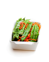 Green  string beans and carrot with spices isolated on white