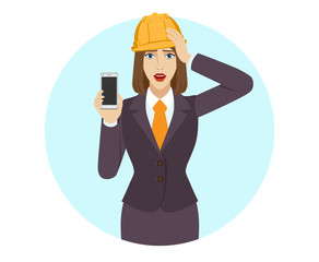 Businesswoman in construction helmet holding a mobile phone and grabbed his head