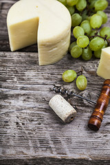 Cheese, grapes, cork and corkscrew
