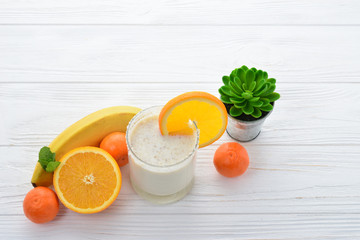 Ice cream with caramel and popcorn on a white table.