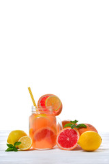 Summer detox drink with fresh fruits in glass jar.