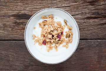 Yogurt with granola in a bowl on wooden table, Healthy and Clean food