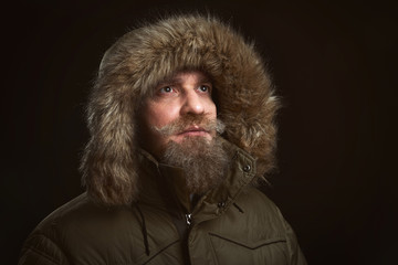 bearded man in brown fur coat