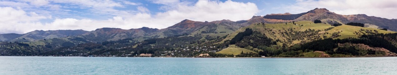 Fototapeta na wymiar A panoramic view of Akaroa, on the Banks Peninsula New Zealand from the sea