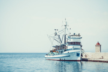 Fishing trawler in the beautiful harbor of a small town Postira - Croatia, island Brac