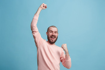 Winning success man happy ecstatic celebrating being a winner. Dynamic energetic image of male model