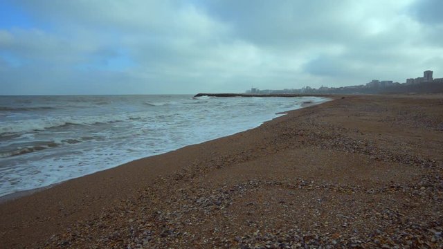 Waves and wind in a cold winter day at the black sea beach with Tomis port  in the background