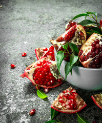 Ripe pieces of pomegranate in a bowl.
