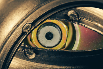Unusual robotic eye in steampunk style. Focused robot look. Background pattern close-up.
