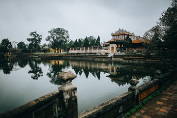 Fototapeta premium beautiful calm pond and ancient oriental architecture in Hue, Vietnam