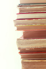 dusty knowledge of the past/ vertical stack of very old books of different sizes