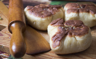 pies with meat and rolling pin on the table