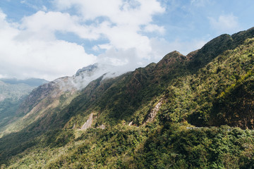 Fototapeta premium beautiful landscape with green trees on mountains and cloudy sky in Sa Pa, Vietnam