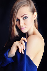 Fototapeta premium Portrait of a beautiful young woman with long hair on a black background