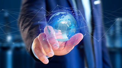 Businessman holding a Connected network over a earth globe concept on a futuristic interface - 3d rendering