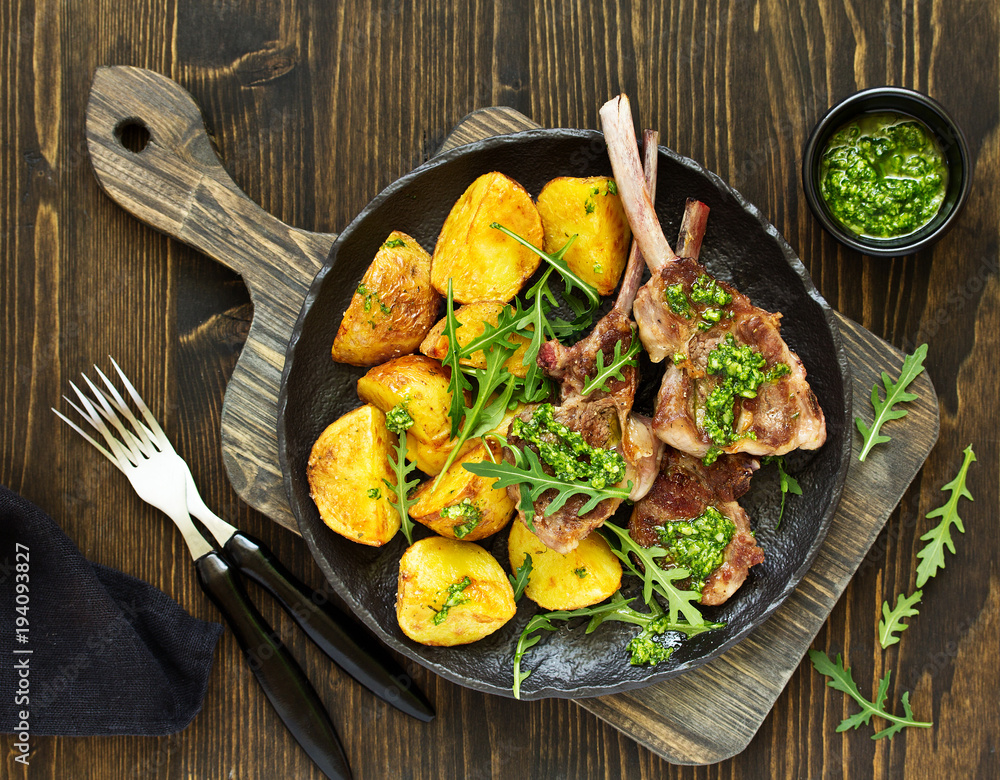 Canvas Prints chops of lamb on bone, with baked potatoes and pesto sauce.